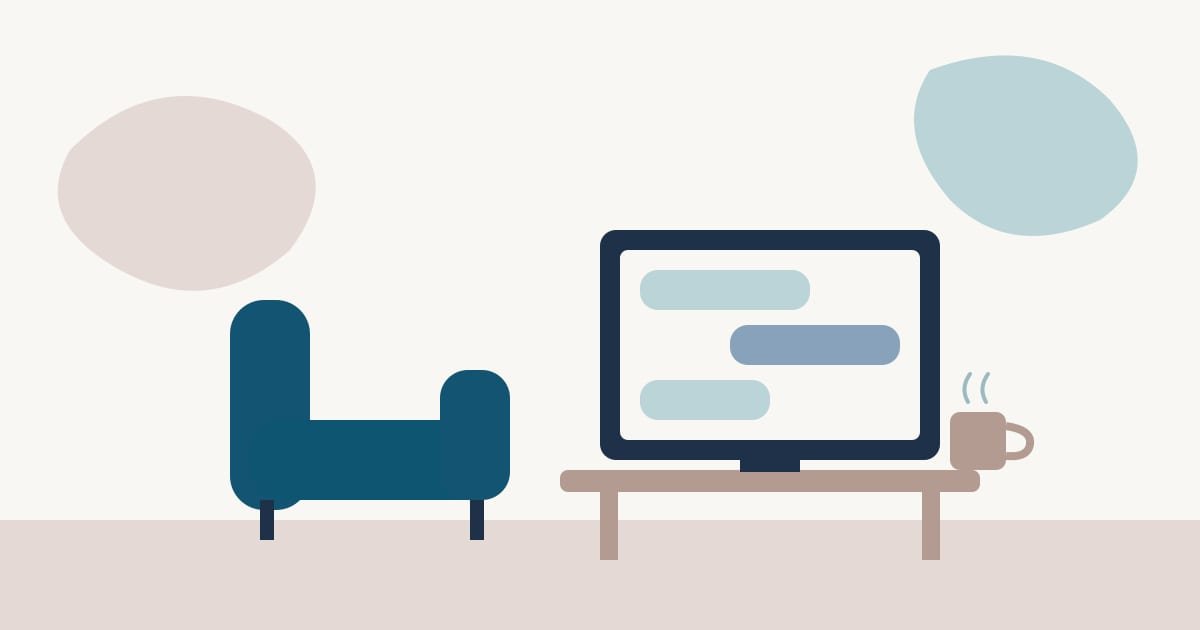 Una pantalla con una conversación de chat sobre una mesa y, al lado, un sillón vacío