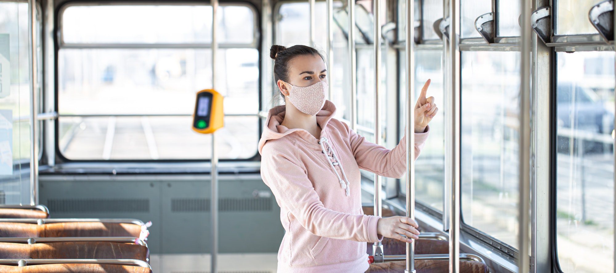 A young woman on public transport during the pandemic.