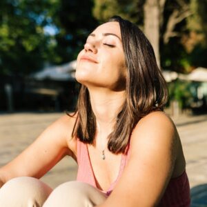 Young woman breathing deep fresh air