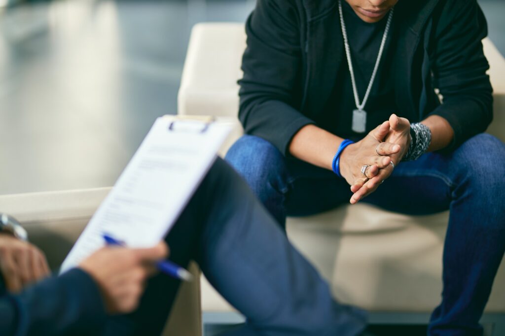 Close-up of African American adolescent during psychotherapy session.